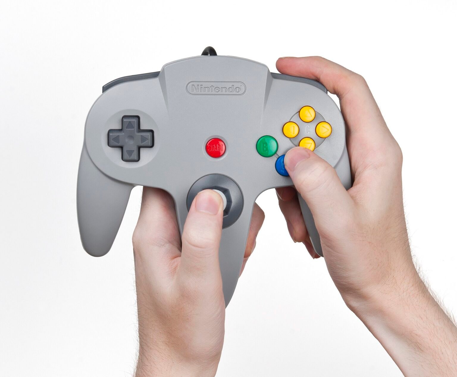 Hands holding a game controller while playing